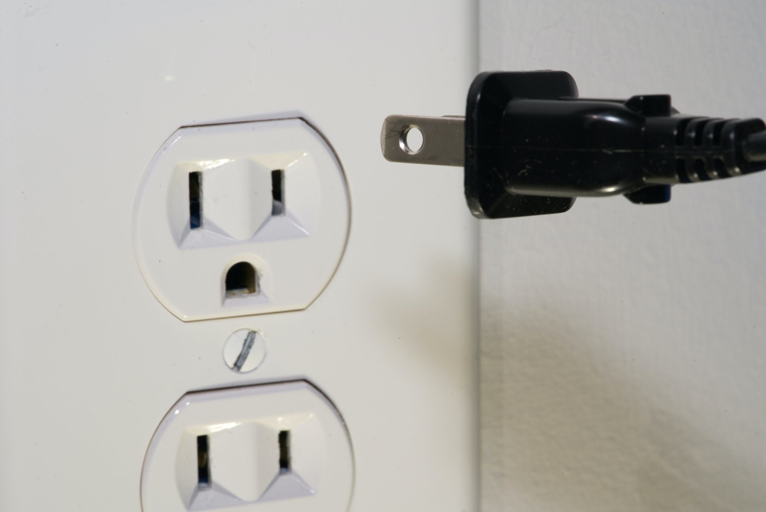 A close-up of an electrical outlet and plug